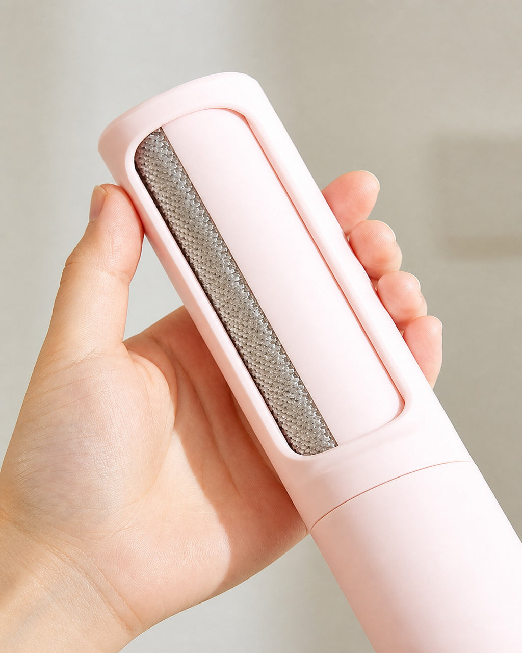 Reusable lint roller held in one hand